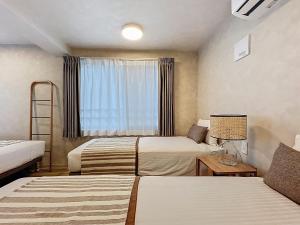 Ένα ή περισσότερα κρεβάτια σε δωμάτιο στο Viento Ikebukuro