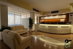 a reception area of a hospital with couches and a lobby at Hotiday Porto Cesareo in Porto Cesareo