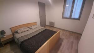a bedroom with a large bed in a room at 2-bed apartment in Limoges