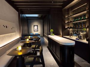 una fila de mesas en un restaurante con bar en Soori Penang, en George Town