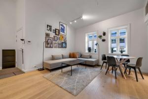 a living room with a couch and a table at Northstay - Town Square in Tromsø