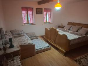 a living room with two beds and a couch at Salaš Trikić in Aleksandrovo