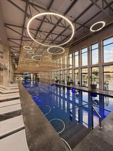 a large swimming pool with a large chandelier in a building at IVORY resort and spa in Vynohradiv