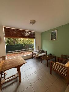 a living room with a couch and a large window at Le Corail - plages - parking - clim - wifi in La Saline les Bains +1 photo