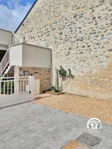 un bâtiment avec une porte et un mur de briques dans l'établissement Gîte Le 47, 6 à 8 personnes, à Louverné