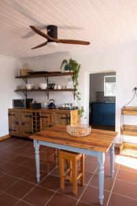 une cuisine avec une table en bois et un plafond dans l'établissement Casa Del Sol Cottage, à McGregor