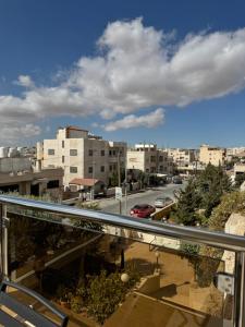 a view of a city from a balcony at COCO Guesthouse in Madaba