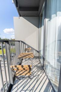 two chairs and a table on a balcony at Sky Pool Escape Luxury Apartment in Druskininkai Center in Druskininkai