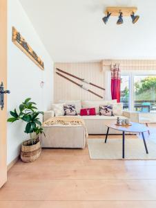 a living room with a couch and a table at Cosy Centered with Garden and View in Veysonnaz in Veysonnaz