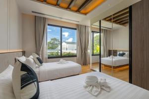 a bedroom with two beds and a large window at Layana Residence in Layan Beach +186 photos