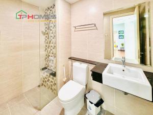 a bathroom with a toilet and a sink at TPHomes Vista Verde in Ho Chi Minh City