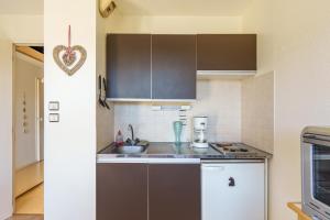 a kitchen with a sink and a counter top at Le Cocon du Chaud Costet - Avec balcon in Le Tholy