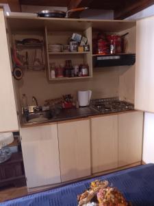 a kitchen with a sink and a stove top oven at Appartamento Valle di Cadore in Valle di Cadore