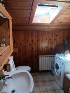 a bathroom with a sink and a washing machine at Appartamento Valle di Cadore in Valle di Cadore +3 photos