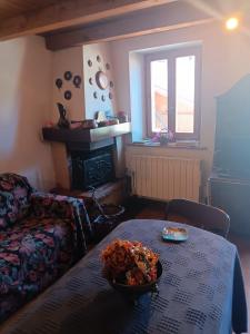 a living room with a table with a bowl of food on it at Appartamento Valle di Cadore in Valle di Cadore