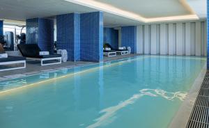 リスボンにあるエボリューション リスボア ホテルのホテルの部屋にある青い水の大きなプール +47枚の写真