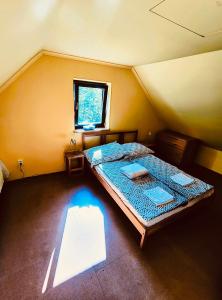 a room with a large bed in a attic at Chata Domeček in Liberec