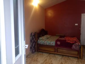 a small bedroom with a bed and a window at December Holiday inn 1 Bedroom House with 2 tent houses in Kodaikānāl