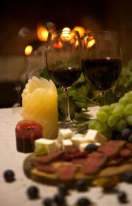 a table with two glasses of red wine and cheese at FAMILY GUEST HOUSE Nikola 