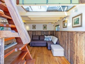 a living room with a couch and a staircase at Snug Holiday Home in Nieuwvliet in Nieuwvliet +85 photos