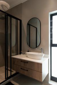 a bathroom with a sink and a mirror at Walton Cottages of Mill Park, Port Elizabeth in Port Elizabeth +29 photos