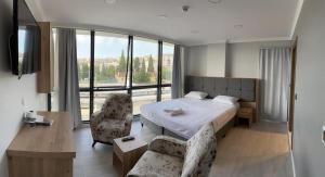 a bedroom with a bed and a couch and a chair at The my hotel darica in Darıca