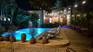a pool with chairs and plants in a building at Explorers Kilimanjaro Boutique Hotel in Moshi