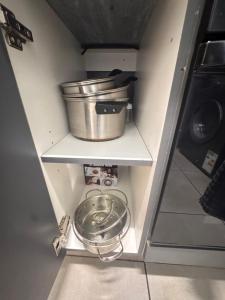 a shelf with a pot and a bucket in a kitchen at Waterfall Bay in Midrand