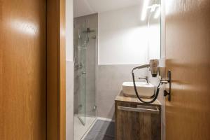 a bathroom with a sink and a shower at Pension Bergwelt in Neustift im Stubaital +57 photos