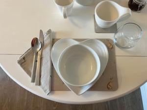 a white plate in the shape of a heart on a table at Luxury Guest Suite Dog Friendly in North Scarle