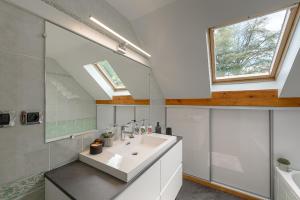 a bathroom with a sink and a mirror at Villa Signature - Vue Panoramique 9p in Sévrier +29 photos