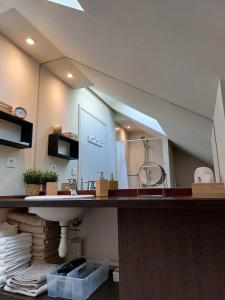a bathroom with a sink and a large mirror at Le Rubis - hyper centre et proche plage in Dinard +26 photos