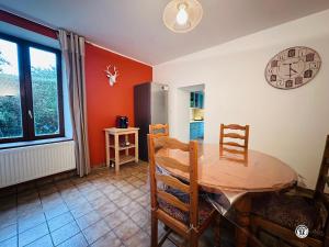 una sala da pranzo con tavolo e frigorifero di Le Lion de Venise a Saulon-la-Rue