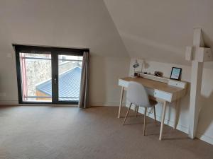 a room with a desk and a chair and a window at Le Rubis - hyper centre et proche plage in Dinard