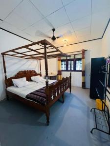 a bedroom with a large wooden bed in a room at Crystal house in Weligama