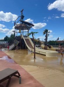 a water park with a slide and a playground at Gîte du Levadon in Rochefort-du-Gard