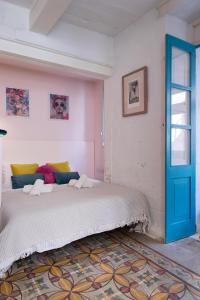 a bedroom with a bed and a blue door at Valletta Letcom Studio in Valletta