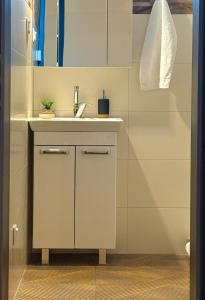 a bathroom with a sink and a mirror at Residence S5 - Comfort Living Apartment in Prešov