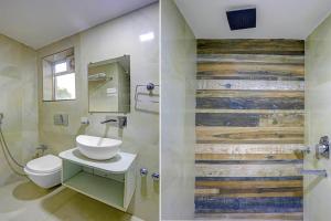 a bathroom with a toilet and a sink and a mirror at Townhouse Oak City Centre Dhanbad Formerly Hotel Kuber Inn in Dhanbād
