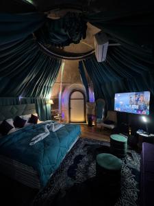 a bedroom with a bed and a tv in a tent at Ufo Mussoorie in Mussoorie