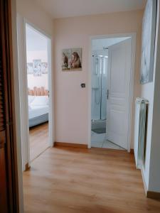 a hallway with a mirror and a bedroom with a bed at Gite Notre Désir in Abriès