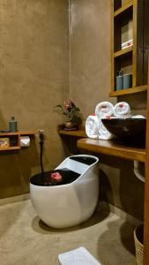 a large white bowl sitting on the floor in a bathroom at Explorers Kilimanjaro Boutique Hotel in Moshi +36 photos