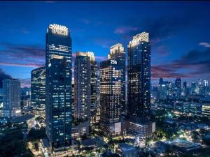 a city skyline with tall skyscrapers at night at 25hours, Hotel, Jakarta The Oddbird in Jakarta
