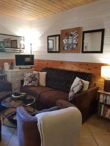 a living room with a couch and a table at Chalet Deleglise 2 in Valfréjus