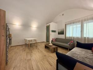 a living room with a couch and a table at The vault of the village, 200 meters from the center and the lake in Lovere