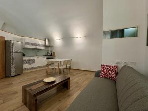 a living room with a couch and a table at The vault of the village, 200 meters from the center and the lake in Lovere