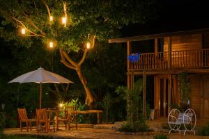 a patio with a table and chairs and an umbrella at Pai Amore in Pai