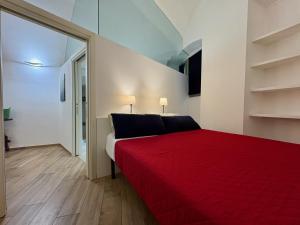 a bedroom with a red bed in a room at The vault of the village, 200 meters from the center and the lake in Lovere