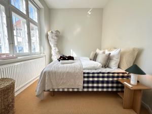 a bedroom with a bed with a stuffed animal on it at Luxury 260 sqm with 4BR overlooking Kings Garden in Copenhagen +68 photos