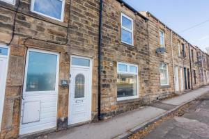 an old brick building with white doors on a street at St Pauls Terrace in Ryhope